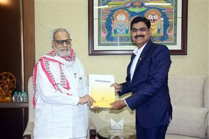 Dr S Mohanty, Chairman, presenting the Annual Report to Hon’ble Governor, Odisha
